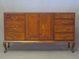 An Eastern hardwood sideboard with double cupboard flanked by  7 drawers, raised on cabriole supports 60"