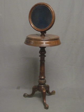 A Victorian mahogany shaving stand, the top with adjustable  mirror, the base fitted a cylindrical box with hinged lid, raised on  turned and fluted column with tripod base 17"
