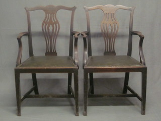 A pair of Chippendale style carver chairs with vase shaped slat  backs and upholstered drop in seats, raised on square tapering  supports with H framed stretcher