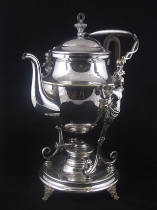 A Continental silver plated tea kettle and stand, supported by 2 semi-naked figures of ladies, raised on a circular base complete  with burner