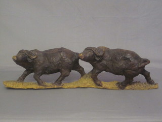 An African carved hardwood figure group of 2 standing  buffaloes 32", some damage to horns,