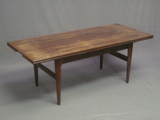 A 1960's rosewood drawleaf coffee table, raised on square supports 55"