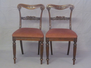 A pair of William IV mahogany bar back dining chairs with  carved mid rails and upholstered drop in seats, raised on reeded  supports
