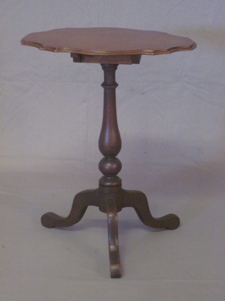 An oval walnut wine table, raised on pillar and tripod supports  21"