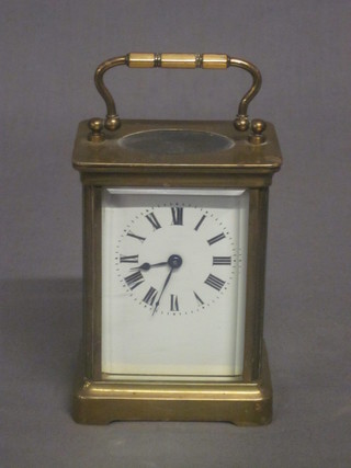 A 19th Century French 8 day carriage clock with enamelled dial  and Roman numerals contained in a gilt metal case   ILLUSTRATED
