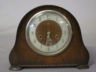 A 1950's 8 day striking mantel clock with silvered dial and Arabic numerals contained in an arch shaped walnut case