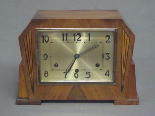 An Art Deco 8 day striking mantel clock with square silvered dial  and Arabic numerals, contained in a walnut case