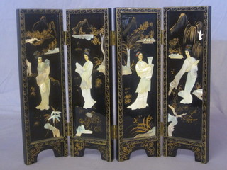 An Oriental black lacquered 4 fold table screen with inlaid mother of pearl decoration depicting Geisha Girls