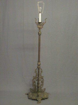 A reeded brass electric standard lamp