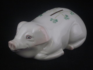 A 20th Century Belleek piggy bank in the form of a reclining  pig, the base with blue Belleek mark and County Fermanagh, 7"