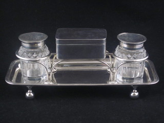 A 19th Century Regency rectangular silver and cut glass standish, having a silver trinket box to the centre with hinged lid, fitted  with cut glass pounce pot and 1 other jar, raised on bun feet,  London 1908 by John Emes, 8 ozs