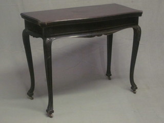 A Victorian shaped mahogany card table, raised on French cabriole supports 36"
