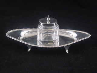 An Edwardian silver boat shaped standish with gadrooned border, raised on panel supports complete with cut glass inkwell,  Sheffield 1903, 4 ozs