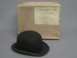 A gentleman's black bowler hat by Lock & Co complete with  original cardboard box