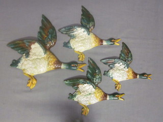 A flight of 4 metal ducks