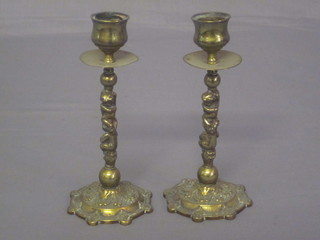 A pair of brass candlesticks the stems decorated cherubs 6"