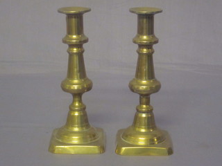 A pair of Victorian brass candlesticks with ejectors 8"