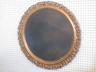 A circular bevelled plate wall mirror contained in a pierced gilt  frame 22"