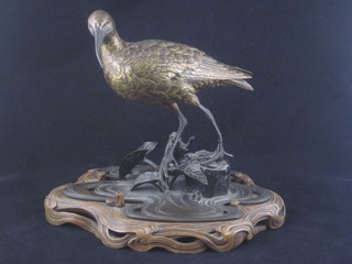 An Oriental gilt bronze figure of a snipe, raised on a pierced base with hardwood stand, the base with seal signature 8"   ILLUSTRATED