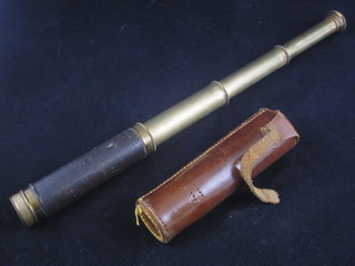A brass 3 draw pocket telescope contained in a leather case