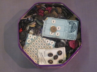 A Quality Street tin containing a large collection of various buttons