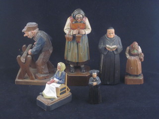 A carved wooden figure of a monk, ditto penguin, ditto  woodsman and 2 others