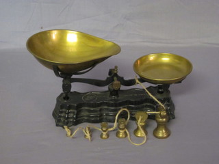 A pair of iron and brass domestic pan scales complete with  weights