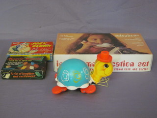 A Yugoslavian toy telephone set, a push-a-long turtle, a mouse  game and a Jolly The Clown game