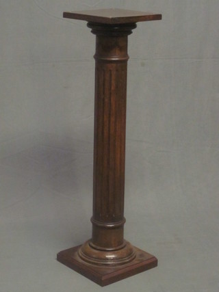 A fluted mahogany pedestal column raised on a square base 41"