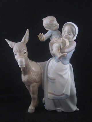 A Lladro figure of a standing lady with baby and donkey 9"