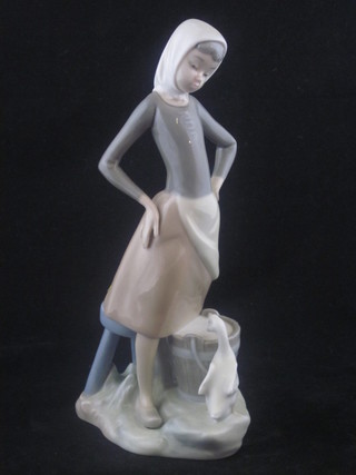 A Lladro figure of a standing girl with bucket and goose 9"