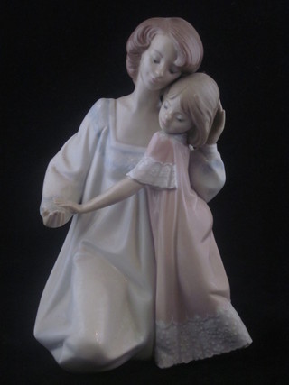 A Lladro figure of a seated mother and daughter, base marked 5449 9"