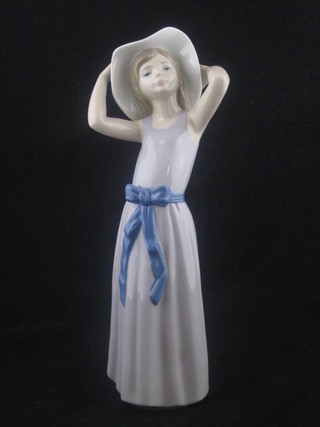 A Lladro figure of a standing bonnetted lady, base marked 5011  10"  ILLUSTRATED