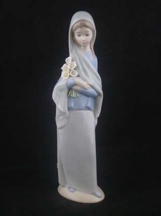 A Lladro figure of a standing lady with lilies, base marked 4650 9"