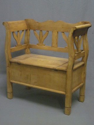 A Continental stripped and polished pine settle with hinged lid  34"