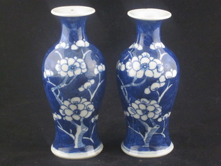 A pair of Oriental porcelain blue and white vases decorated  prunus 5", both chipped,