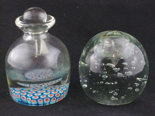 A circular bubble glass paper weight 4" and a glass inkwell with Millefiouri decoration 4"