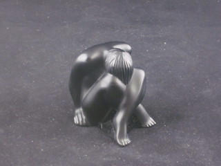 A 1993 Lalique black glass figure of a crouching nude, 2" boxed