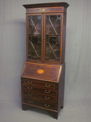 An Edwardian inlaid mahogany bureau bookcase, the upper section with moulded cornice, the interior fitted shelves enclosed  by glazed panelled doors, the base with fall front revealing a well  fitted interior above 4 long graduated drawers with brass swan  neck drop handles, raised on bracket feet 30"