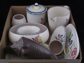 A collection of Poole Pottery comprising egg stand and base,  scallop shaped vase, egg cup, 2 shaped dishes, a small vase,  flower ring, jug and preserve jar