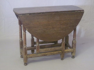 An 18th Century oak drop flap gateleg tea table, raised on  turned and block supports, 35"