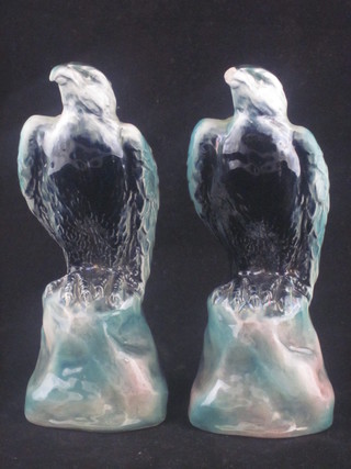 A pair of Shelley blue glazed figures of seated eagles, 7", 1 with chipped beak,