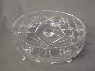 A circular cut glass bowl raised on 3 feet 10"