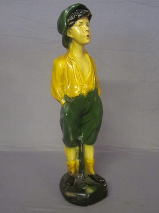 A plaster figure of a standing whistling boy 24"