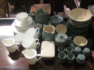 A 32 piece blue glazed Denby dinner service comprising 4 oval plates 10", 4 circular plates 7 1/2", 4 bowls 6 1/2", a salad plate  8", 4 cups and 4 saucers, sugar bowl, lidded twin handled bowl  and cover, 3 piece condiment set comprising salt, pepper and  mustard pot, 4 egg cups, rectangular butter dish and cover, 5"  jug, 6" hotwater jug, 3 1/2" vase, 3" lid, chipped, together with  a 21 piece Aynsley Camille pattern tea service comprising 7  dinner plates 8", 1 with slight chip, 6 cups and 6 saucers and 2  cream jugs