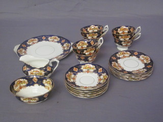 A 21 piece Royal Albert Derby style tea service comprising twin  handled plate 9", 6 plates 6 1/2", 6 cups, 2 cracked, 6 saucers,  sugar bowl, cracked, and cream jug