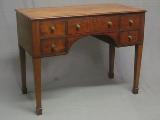 A Georgian mahogany side table, fitted 1 long drawer flanked by  2 short drawers, raised on square tapering supports ending in  spade feet 41"  ILLUSTRATED
