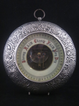 An Edwardian circular aneroid barometer with porcelain dial contained in an embossed silver case, Birmingham 1909   ILLUSTRATED
