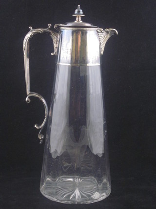 A glass claret jug with plated mounts