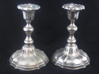 A pair of silver plated stub candlesticks 7"